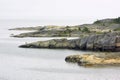 Red cliffs outside north of Arholma in the outer Stockholm Archipelago Royalty Free Stock Photo