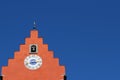 Red clock tower against blue sky-landscape format Royalty Free Stock Photo