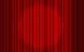 Red closed curtain with light spots in a theater