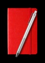 Red closed notebook and pen isolated on black Royalty Free Stock Photo