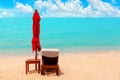 Red umbrella, deck chair, solar parasol, sun lounger, chaise lounge, sun bed, tropical island sea beach, summer holidays, vacation Royalty Free Stock Photo