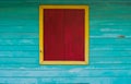 Red closed wooden shutter isolated on the exterior of the green wooden house wall. Royalty Free Stock Photo