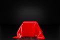 Red cloth pedestal podium on black background, showcase product or cosmetics promotion Royalty Free Stock Photo