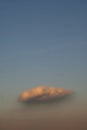 Red cloud on dark blue sky at sunset