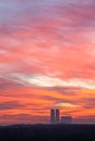 red clouds in dawn sky over city park and towers Royalty Free Stock Photo