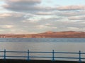 The red clouds making across water reddish also