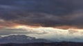 Red clouds over the snow-capped peaks of the Apennine mountains