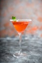 Red cocktail with bloody oranges in martini glass on the rustic background Royalty Free Stock Photo