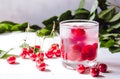 Red cocktail with cherry and ice on a white wooden background. Fresh summer cocktail with cherries and ice cubes Royalty Free Stock Photo