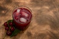 Red cocktail. Cherry juice with ice. Cherry leaves and cherry berries. The summer aroma of coolness in a glass. Juccy Royalty Free Stock Photo