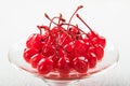 Red cocktail cherry on a platter on a white background. Royalty Free Stock Photo