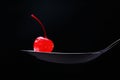 Red cocktail cherry on spoon Royalty Free Stock Photo