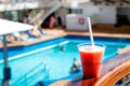 Red cocktail drink in the pool