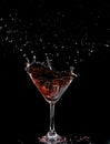 Red Cocktail Glass with splashing water alcohol, Crystal Cocktail drink splatter splash in air and bubble from glass. Liquor Part Royalty Free Stock Photo