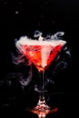 Red cocktail with ice vapor