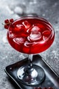 red cocktail with ice vapor. Cocktail with smoke. Alcohol drink, vodka, ice, party, dry ice