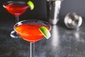 Red cocktail with lime in Martini glass Royalty Free Stock Photo