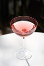 Red cocktail in martini glass with cherry. Exotic alcoholic cocktail Royalty Free Stock Photo