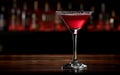 Red cocktail in martini glass with garnish on dark bar background,closeup,copy space,lifestyle Royalty Free Stock Photo