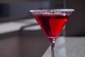 Red cocktail in a Martini glass on a gray background. Red liquid in a glass. Glass beaker Royalty Free Stock Photo