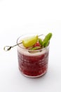 Red cocktail, drink with ice cubes, garnished with mint and lemon, isolated on white background, selective focus. Royalty Free Stock Photo