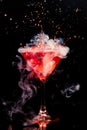 Red cocktail with splash and ice vapor