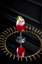 red cocktail with whipped cream instead of topping and mint leaves, side view Royalty Free Stock Photo