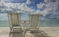 Red cocktail on white table set over ocean Royalty Free Stock Photo