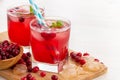 Red coctail with cranberry, vodka and ice.