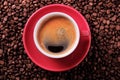 Red coffee cup with espresso and roasted beans closeup Royalty Free Stock Photo