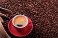 Red coffee cup with espresso and roasted beans background Royalty Free Stock Photo