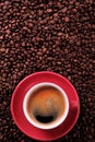 Red coffee cup with espresso and roasted beans vertical copy space Royalty Free Stock Photo