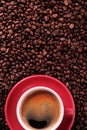 Red coffee cup with espresso and roasted beans vertical Royalty Free Stock Photo