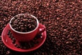 Red coffee cup filled with dark roasted beans Royalty Free Stock Photo