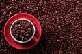 Red coffee cup filled with roasted beans background Royalty Free Stock Photo