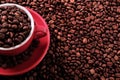 Red coffee cup filled with roasted beans Royalty Free Stock Photo