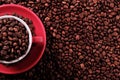 Red coffee cup filled with roasted beans top view Royalty Free Stock Photo