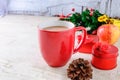 Red Coffee Cup and Red Gift Box with Christmas Tree on White Background Royalty Free Stock Photo