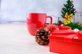 Red Coffee Cup and Red Gift Box with Christmas Tree on White Background Royalty Free Stock Photo