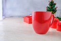 Red Coffee Cup and Red Gift Box with Christmas Tree on White Background Royalty Free Stock Photo
