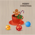 Red coffee cup with gingerbread man cookee and candy cane decorated green leafs, boughs spruce and snowfalls near Christmas balls Royalty Free Stock Photo