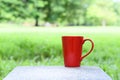 Red coffee cup on green natural background Royalty Free Stock Photo