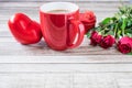 Red coffee cup with heart and rose Valentines Day concept