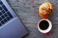 Red coffee cup and Tasty buns with latop computer on wood table for life style technology digital nomad backgrounds above