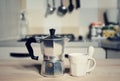 Red coffee cup and vintage coffeepot on kitchen stove Royalty Free Stock Photo