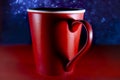 Red coffee or tea cup, heart symbol form in shadow
