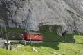 Red cogwheel train between railway station Alpnachstad and mountain Pilatus Kulm.