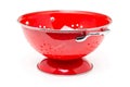 Red colander over white background Royalty Free Stock Photo
