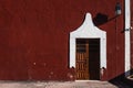 Red Colonial building with wooden door, Valladolid, Yucatan, Mexico