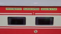 Red color air conditioned Passenger Train coach of the Rajdhani Express during night.